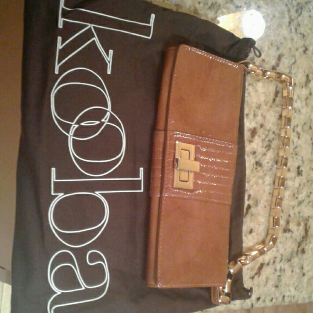 Clutch with metal shoulder strap